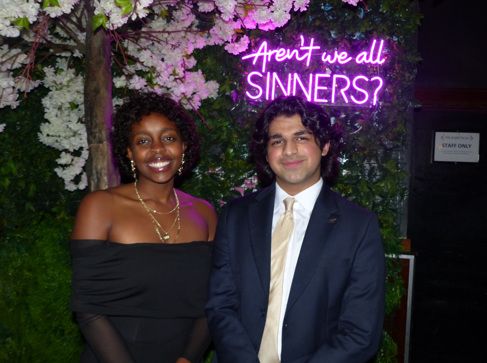 AUCFS committee members at event with neon sign
